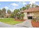 Inviting condo exterior featuring a cozy balcony, well-maintained lawn, and picturesque palm trees at 816 Club Cottage Rd, Edisto Beach, SC 29438