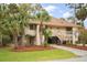 Inviting two-story condo features palm trees, well-kept lawn, and ground-level covered parking at 816 Club Cottage Rd, Edisto Beach, SC 29438