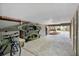 Well-lit garage featuring kayak storage, bike rack, and open space for various recreational equipment and activities at 816 Club Cottage Rd, Edisto Beach, SC 29438