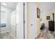 Hallway leading to a full bathroom and a bedroom with wood-look flooring at 816 Club Cottage Rd, Edisto Beach, SC 29438