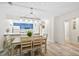 Bright kitchen and dining area with blue accents, white cabinetry and counters, and wood floors at 816 Club Cottage Rd, Edisto Beach, SC 29438