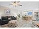 Comfortable living room featuring an open floor plan and wood-look floors connecting to the kitchen at 816 Club Cottage Rd, Edisto Beach, SC 29438