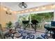 Enclosed patio space with charming decor, string lights, comfortable seating, and view of the lush outdoor scenery at 816 Club Cottage Rd, Edisto Beach, SC 29438