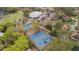 Aerial view of well-maintained tennis courts next to the parking, surrounded by lush trees at 816 Club Cottage Rd, Edisto Beach, SC 29438