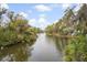 Picturesque water view showcasing a serene waterway surrounded by lush greenery and mature trees at 816 Club Cottage Rd, Edisto Beach, SC 29438