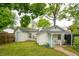 Charming backyard with lush green grass, mature trees, and a cozy porch for outdoor enjoyment at 85 Colleton Dr, Charleston, SC 29407