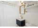 Modern bathroom with a sleek vanity, gold fixtures, and a shower with a stylish shower curtain at 85 Colleton Dr, Charleston, SC 29407