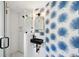Stylish bathroom with palm wallpaper, a vessel sink, and a glass-enclosed shower at 85 Colleton Dr, Charleston, SC 29407