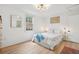 Cozy bedroom featuring a plush bed with light-colored walls and wood floors at 85 Colleton Dr, Charleston, SC 29407