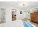 Comfortable bedroom with light walls, a wooden dresser, and hardwood floors at 85 Colleton Dr, Charleston, SC 29407