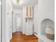 Bright hallway features hardwood floors, storage cabinets, and an arched display shelf with decorative vase at 85 Colleton Dr, Charleston, SC 29407