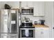 Modern kitchen with stainless steel appliances, ample counter space, and stylish white cabinets at 85 Colleton Dr, Charleston, SC 29407