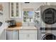 Functional laundry area with a farmhouse sink, modern appliances, and wood countertops at 85 Colleton Dr, Charleston, SC 29407