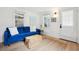 Cozy living room features a blue sofa, jute rug, ample natural light, and a view of the backyard at 85 Colleton Dr, Charleston, SC 29407