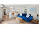 Stylish living room features a plush blue sofa, a jute rug, and a modern bar area at 85 Colleton Dr, Charleston, SC 29407