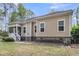 A cozy backyard with a screened porch and green landscaping, perfect for outdoor gatherings at 8618 Mcchune Ct, North Charleston, SC 29420
