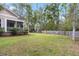 Expansive backyard featuring a screened-in porch and mature trees at 8618 Mcchune Ct, North Charleston, SC 29420