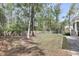 Large backyard featuring a privacy fence, shade trees, and a well-maintained lawn at 8618 Mcchune Ct, North Charleston, SC 29420