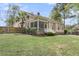 Inviting backyard featuring a screened porch, lush greenery, and partial fencing for privacy at 8618 Mcchune Ct, North Charleston, SC 29420