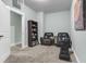 Cozy basement rec room with plush carpet, seating, and built-in shelving for entertainment at 8618 Mcchune Ct, North Charleston, SC 29420