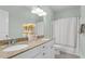 Well-lit bathroom features a double vanity, granite countertop and shower tub combination at 8618 Mcchune Ct, North Charleston, SC 29420