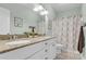 Bright bathroom featuring double vanity, granite counters, and a decorative shower curtain at 8618 Mcchune Ct, North Charleston, SC 29420