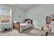 Cozy bedroom with natural light and a warm color scheme; a perfect place to wind down and relax at 8618 Mcchune Ct, North Charleston, SC 29420