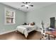 Well-lit bedroom with hardwood floors, a fan, and large window at 8618 Mcchune Ct, North Charleston, SC 29420