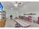 Carpeted bonus room with fan, window, desk, shelves, workout equipment, and mounted TV at 8618 Mcchune Ct, North Charleston, SC 29420