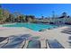 Beautiful community pool with lounge chairs, lifeguard stand and clear blue water for a relaxing experience at 8618 Mcchune Ct, North Charleston, SC 29420