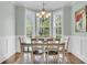 Traditional dining room featuring large windows and a modern chandelier at 8618 Mcchune Ct, North Charleston, SC 29420