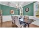 Inviting dining room featuring wainscoting, hardwood floors, elegant lighting and seating for four at 8618 Mcchune Ct, North Charleston, SC 29420