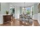 Dining room boasts a view of the living room, wood floors, and neutral colors at 8618 Mcchune Ct, North Charleston, SC 29420