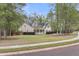 Beautiful home with a welcoming front porch, manicured lawn, and mature trees at 8618 Mcchune Ct, North Charleston, SC 29420