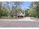 Charming home with a welcoming front porch, well-manicured lawn, and a long driveway at 8618 Mcchune Ct, North Charleston, SC 29420