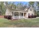 Charming home with a welcoming front porch, manicured lawn, and fresh landscaping at 8618 Mcchune Ct, North Charleston, SC 29420