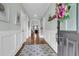 Bright foyer with hardwood floors, wainscoting, and an open view of the living spaces at 8618 Mcchune Ct, North Charleston, SC 29420
