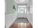 Elegant foyer featuring hardwood floors, wainscoting, and a decorative wreath on the door at 8618 Mcchune Ct, North Charleston, SC 29420