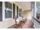 Charming front porch with rocking chairs, decorative pillows, and ample natural light at 8618 Mcchune Ct, North Charleston, SC 29420