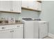 Bright laundry room boasts modern washer and dryer, along with lots of cabinet storage at 8618 Mcchune Ct, North Charleston, SC 29420
