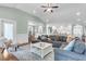 Spacious living room with hardwood floors, comfortable seating, and an open floor plan at 8618 Mcchune Ct, North Charleston, SC 29420