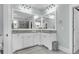 Bright main bathroom with double sink vanity, granite counters, and decorative mirrors at 8618 Mcchune Ct, North Charleston, SC 29420