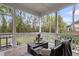 Relaxing screened porch with seating and a view of the backyard at 8618 Mcchune Ct, North Charleston, SC 29420