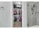 Walk-in closet with clothes on racks and shelving next to a shower at 8618 Mcchune Ct, North Charleston, SC 29420