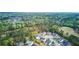 A scenic aerial view of homes and community, surrounded by dense woods and a golf course at 9447 Harroway Rd, Summerville, SC 29485