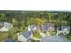 Aerial view of homes in a suburban neighborhood, surrounded by lush, mature trees at 9447 Harroway Rd, Summerville, SC 29485