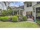 Spacious backyard with a patio, lush landscaping, and charming outdoor features at 9447 Harroway Rd, Summerville, SC 29485