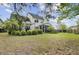 Expansive backyard with well-maintained lawn and a screened-in porch, ideal for relaxing at 9447 Harroway Rd, Summerville, SC 29485
