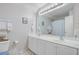 Bright bathroom featuring a double vanity, large mirror, and nautical themed decorations at 9447 Harroway Rd, Summerville, SC 29485