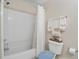 Cozy bathroom featuring shower with white curtain, seashell towels, and decor at 9447 Harroway Rd, Summerville, SC 29485
